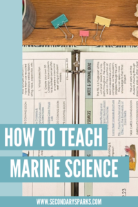 pacing guide for a marine science class on a desk with school supplies