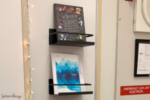 magnetic shelves on a white board holding an interactive science notebook