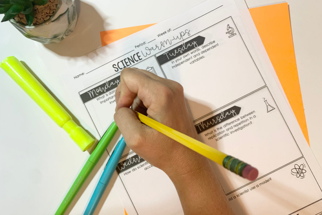 Students completing daily middle school science warm-ups at their desks, demonstrating a predictable classroom management routine to help avoid teacher burnout.